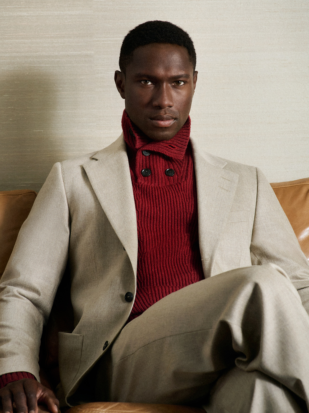 beige suit and red knitwear